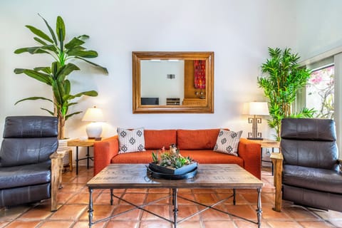 Bright living room with fireplace and greenbelt patio access
