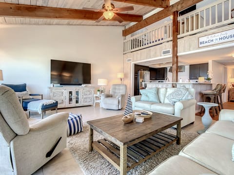 Oceanfront living room with recliner, plenty of seating, and smart TV.
