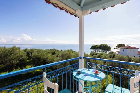 Sunny private balcony with outdoor dining table and open views
