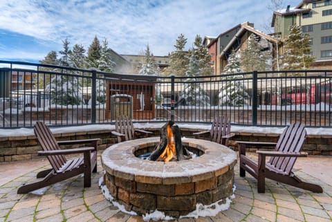 Gas Firepit & Adirondack Chairs next to Hot Tubs in Winter