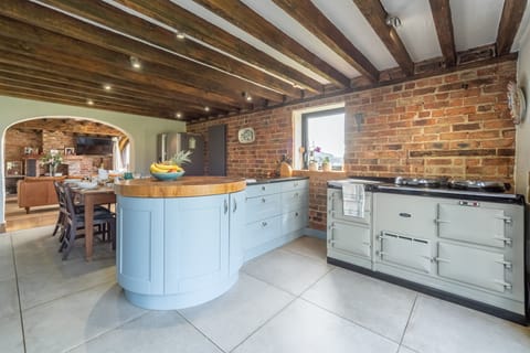 Ground floor: Kitchen with island unit and duck egg blue, four oven Aga