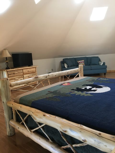 Another view of Tower bedroom with sofa dresser and television- very spacious.