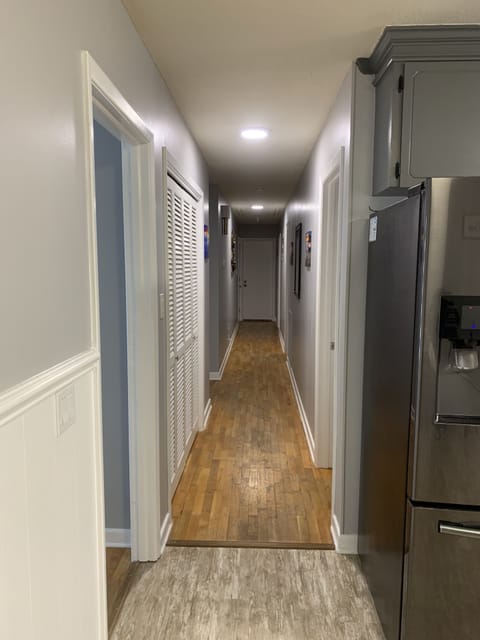 Kitchen looking down hall to last bedroom 