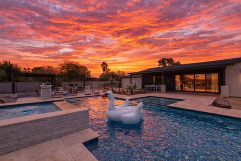 Backyard Resort featuring a sparkling blue oasis and spa, BBQ grill, Covered Patio w/ Outdoor Dining, fire pit and a Sports Court!