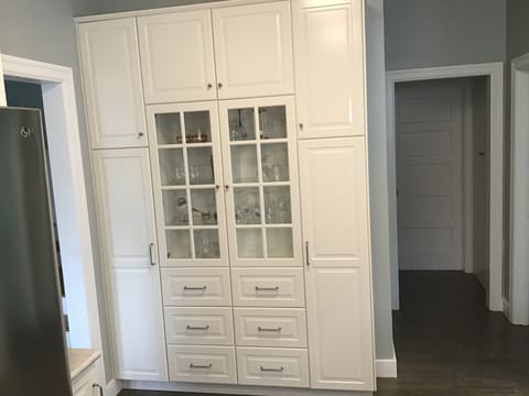 Kitchen hutch filled with wine glasses.