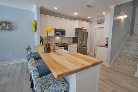Butcher block countertops extend to the large breakfast bar.