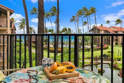 Enjoy balcony dining framed by gardens and palms.