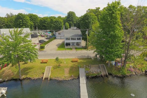 The Inn at Highland Lake with waterfront yard across street with a dock