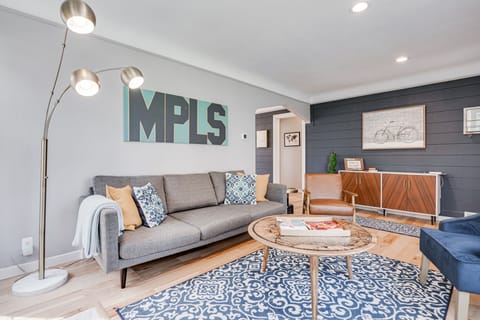 Sink into this stylish living room where modern comfort meets Minneapolis charm, complete with cozy seating and warm lighting for your perfect stay.