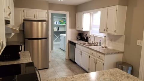Large kitchen with coffee maker, crockpot, and Brita filtered water.