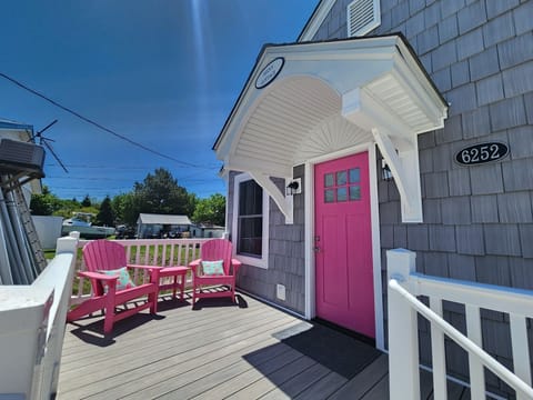Relax on the charming front porch with Adirondack chairs, perfect for morning coffee or winding down in the evening.