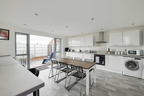 Kitchen: Bright and airy culinary space with modern appliances and sliding doors to enjoy fresh air!
