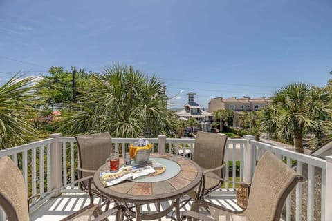 Deck with table, chairs, and palm tree views