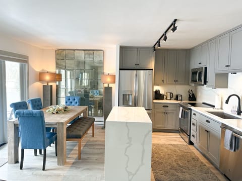 Fully stocked kitchen and dining area with Restoration Hardware furnishings 