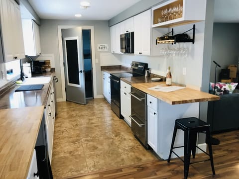 Fully stocked kitchen • Bar Area • Natural light • Farmhouse sink • Plants
