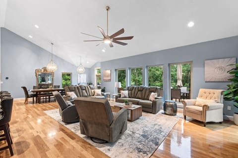 Cozy up in the spacious living area with vaulted ceilings and wooded views.