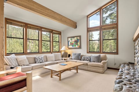 Our main living space features two large couches with room for the entire family, a fireplace and windows that bring in plenty of natural light. 