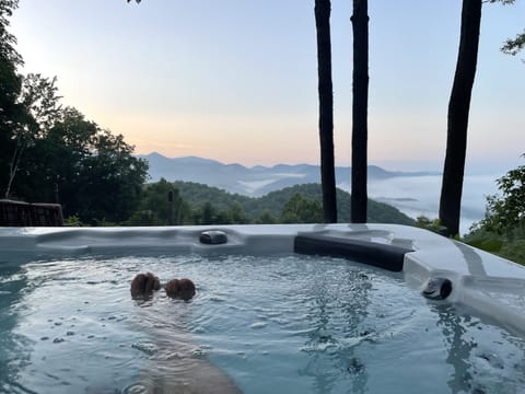 Relax and unwind in large hot tub while taking in the OMG mountain views.