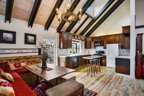 Open kitchen/dining room with high ceilings, deck, TV

