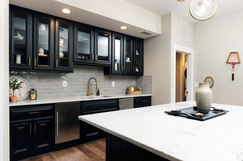 Wet bar in game room with mini fridge and freezer