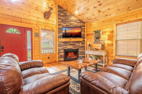 Relax in a warm, open living space with soaring ceilings and a cozy fireplace
