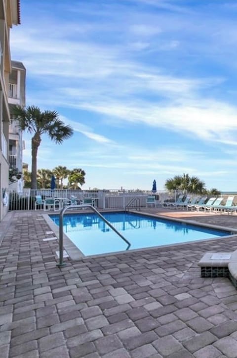 Heated pool & patio with outdoor kitchen overlooks the glittering Gulf of Mexico