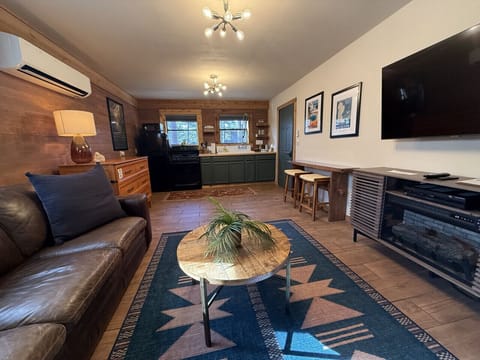 Open floor plan with leather seating, full kitchen, fireplace, and full bed hideway.