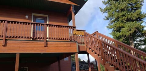 Private staircase up to the Whitetail View balcony entrance with two doors.