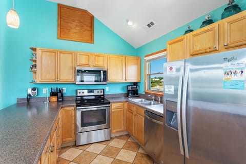 Whip up a quick meal in the neighboring fully-stocked open-concept Kitchen with stainless steel appliances and bar seating!