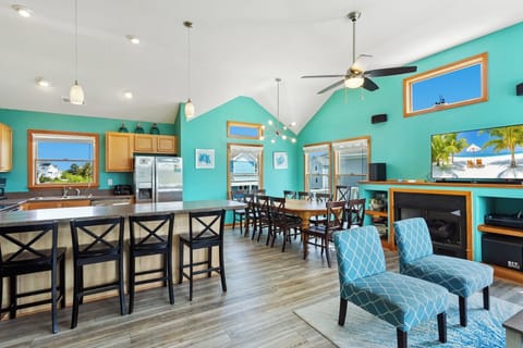 Enjoy time together in the spacious Living Area with High Ceilings and Lots of Light! (*Please note: Fireplace is not for guest use.)