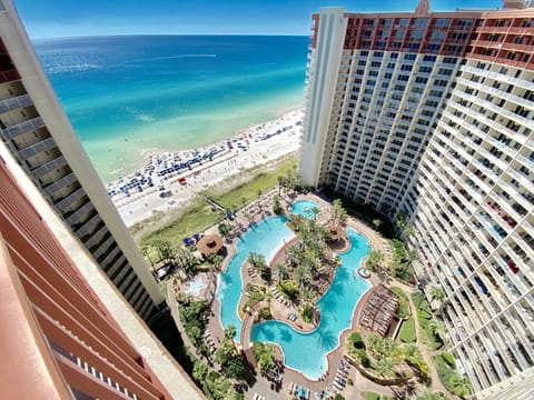 View of epic pool, tiki bar & grill, hot tub, and gulf from balcony