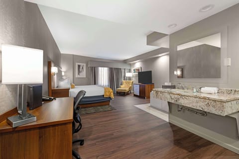 Suite, 1 King Bed, Non Smoking, Jetted Tub | Desk, laptop workspace, blackout drapes, iron/ironing board
