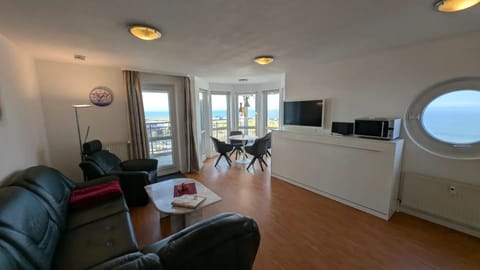Living room with dining area and large windows facing the sea - Living room