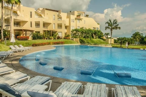 Spacious pool and garden area with sun loungers
