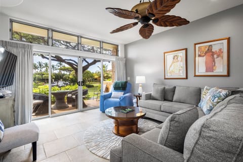 Sink into plush sofas beneath tropical ceiling fans and let lush garden views through floor-to-ceiling glass doors bring island serenity right into your living space.