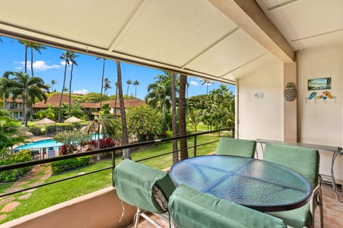 Sip your morning coffee from your private lanai overlooking tropical palms, lush gardens, and the sparkling pool below—your perfect Hawaiian escape awaits.