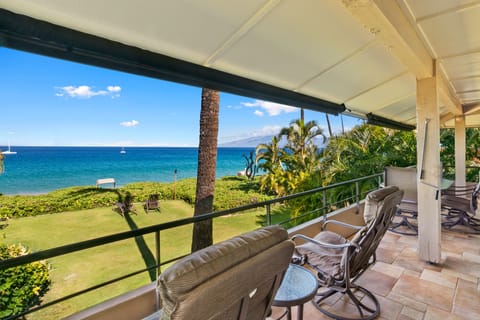Relax in your covered lanai with stunning oceanfront views. Watch sailboats drift across turquoise waters while tropical breezes flow through the lush garden below—your private escape awaits.