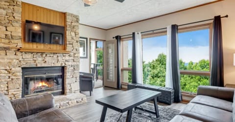 Living Room with Wood Burning Fireplace, Flat Screen RV and Large Windows