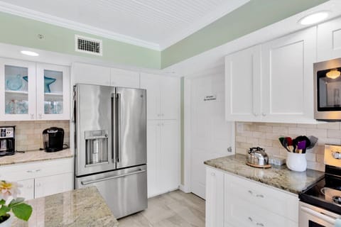 Kitchen with pool and pond views. Dishwasher. Microwave. Oven.