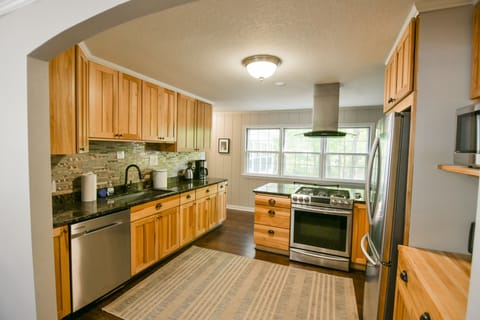 Kitchen with east facing window which overlooks patio and river bluff woods
