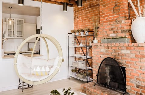 Hanging adult chair in front of fireplace