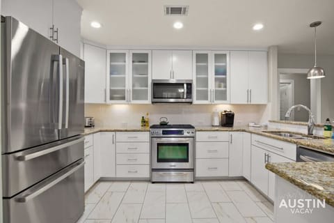 Large kitchen with bar seating and dining area
