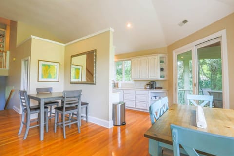 The home features three dining tables -- two indoors and one outdoors on the screened porch.