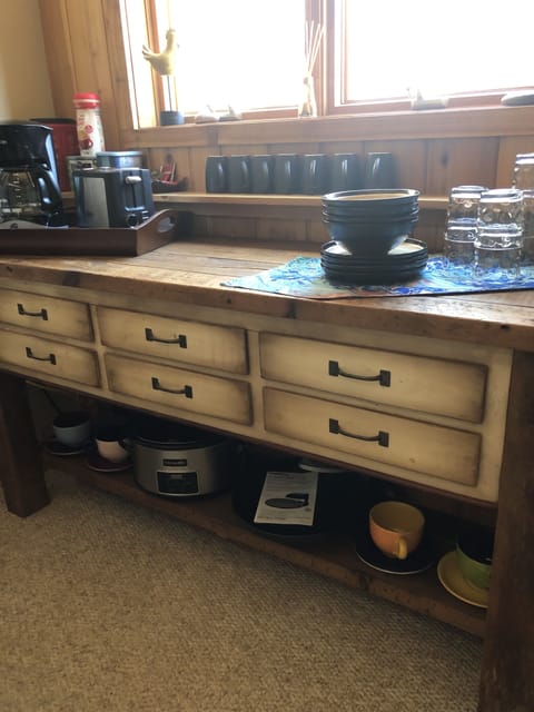 Coffee maker, toaster, crockpot, pizza oven, microwave, and mini fridge.