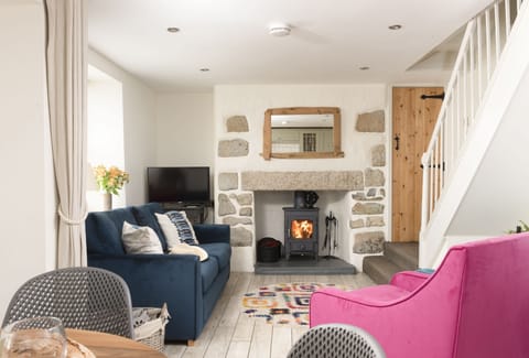 Oriel Cottage, St Agnes. Ground Floor: The chic living area offers the warmth of wood burning stove