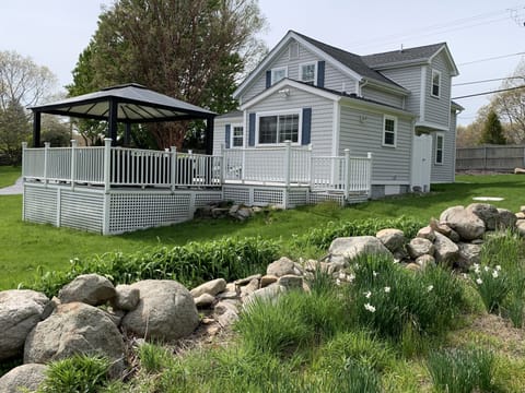 view of house from the extended side yard with the primitive stone wall