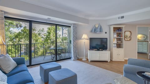 This inviting living space features comfortable seating, coastal-inspired décor, and an open layout ideal for gathering after a day outdoors.