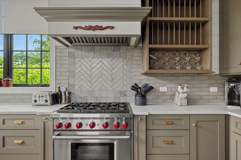 High-end appliances anchor this stunning chef’s kitchen.