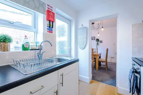 Fully equipped kitchen with an oven, hob, toaster, kettle, microwave and a washer/dryer.