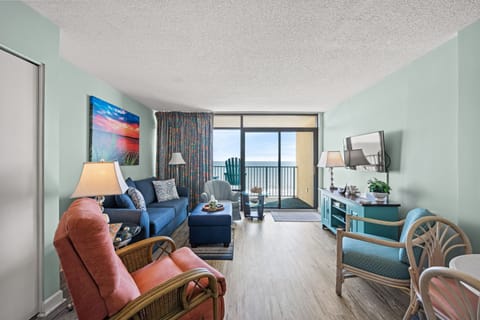 Relax in the comfort of a large well-appointed living room with an ocean view.